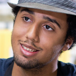 Male student wearing a hat and smiling