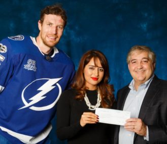 Hockey player, female, and male smiling